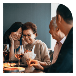 mother and daughter with gift at dinner table