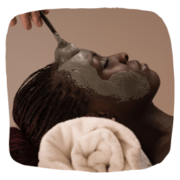 woman of color getting clay facial
